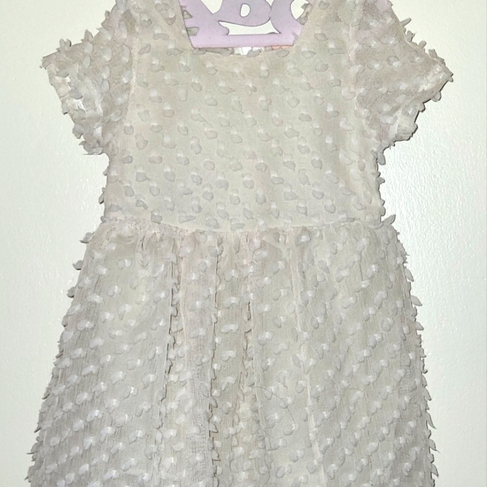 Beige dress with little dots, has a cover underneath, minor break on waist area